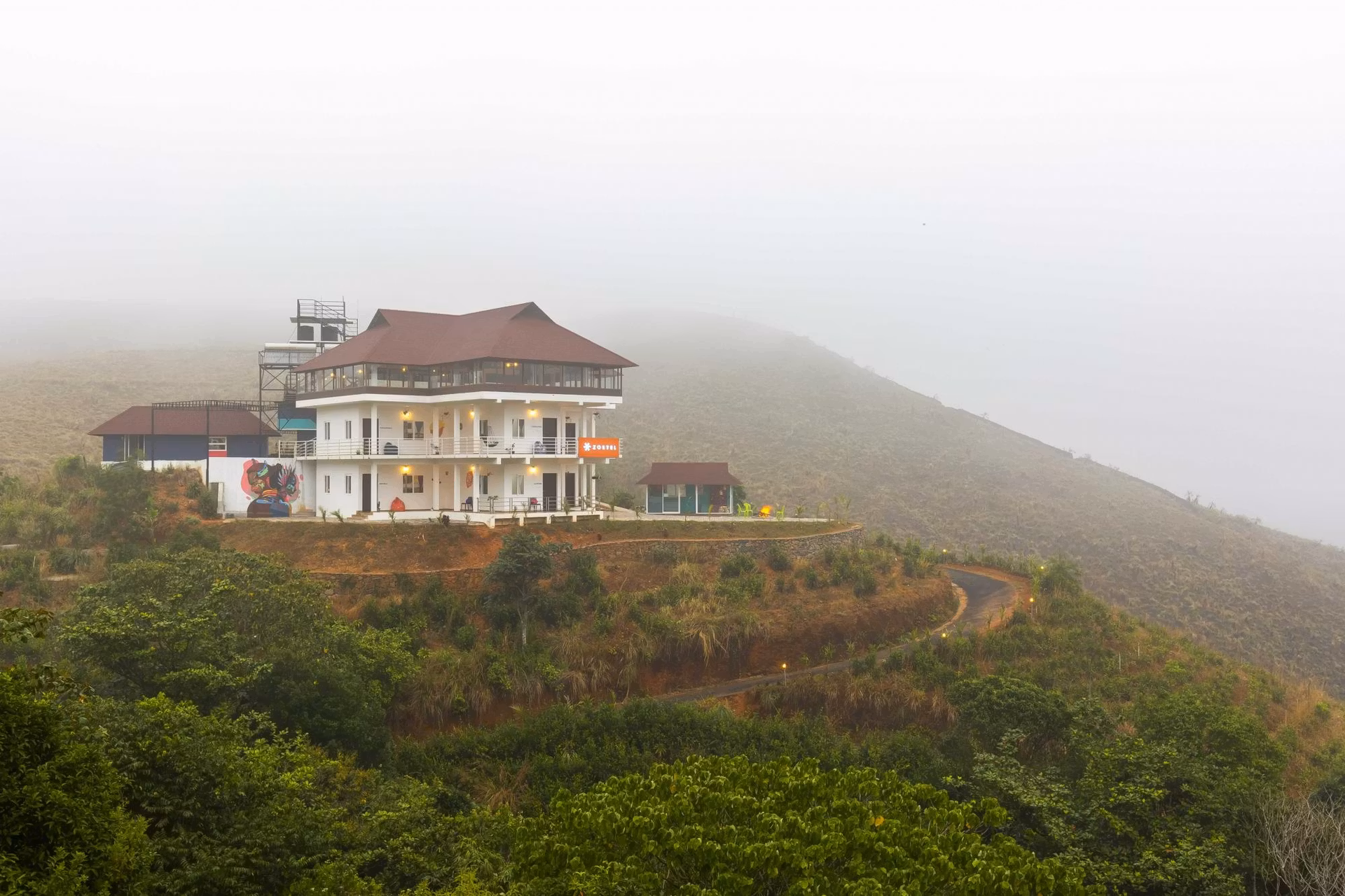 Misty outdoor view of Zostel Vagamon